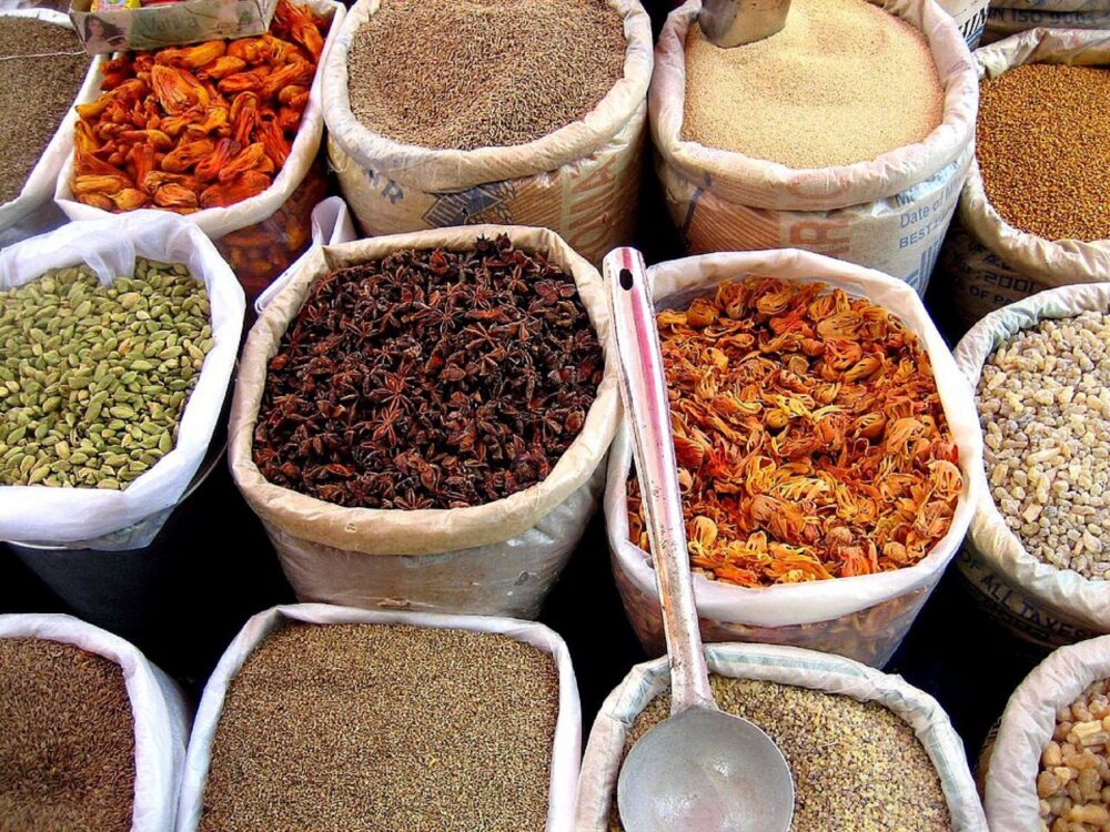 Goods and spices displayed in a busy wholesale-style market