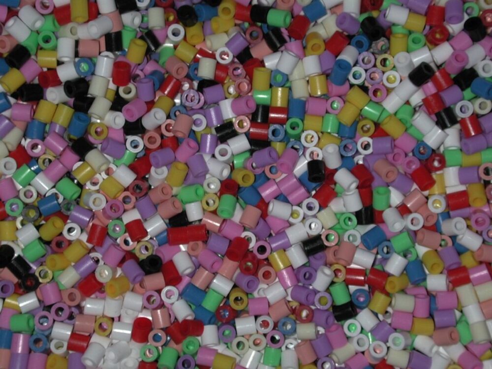 Close-up of colorful fuse beads scattered on a surface