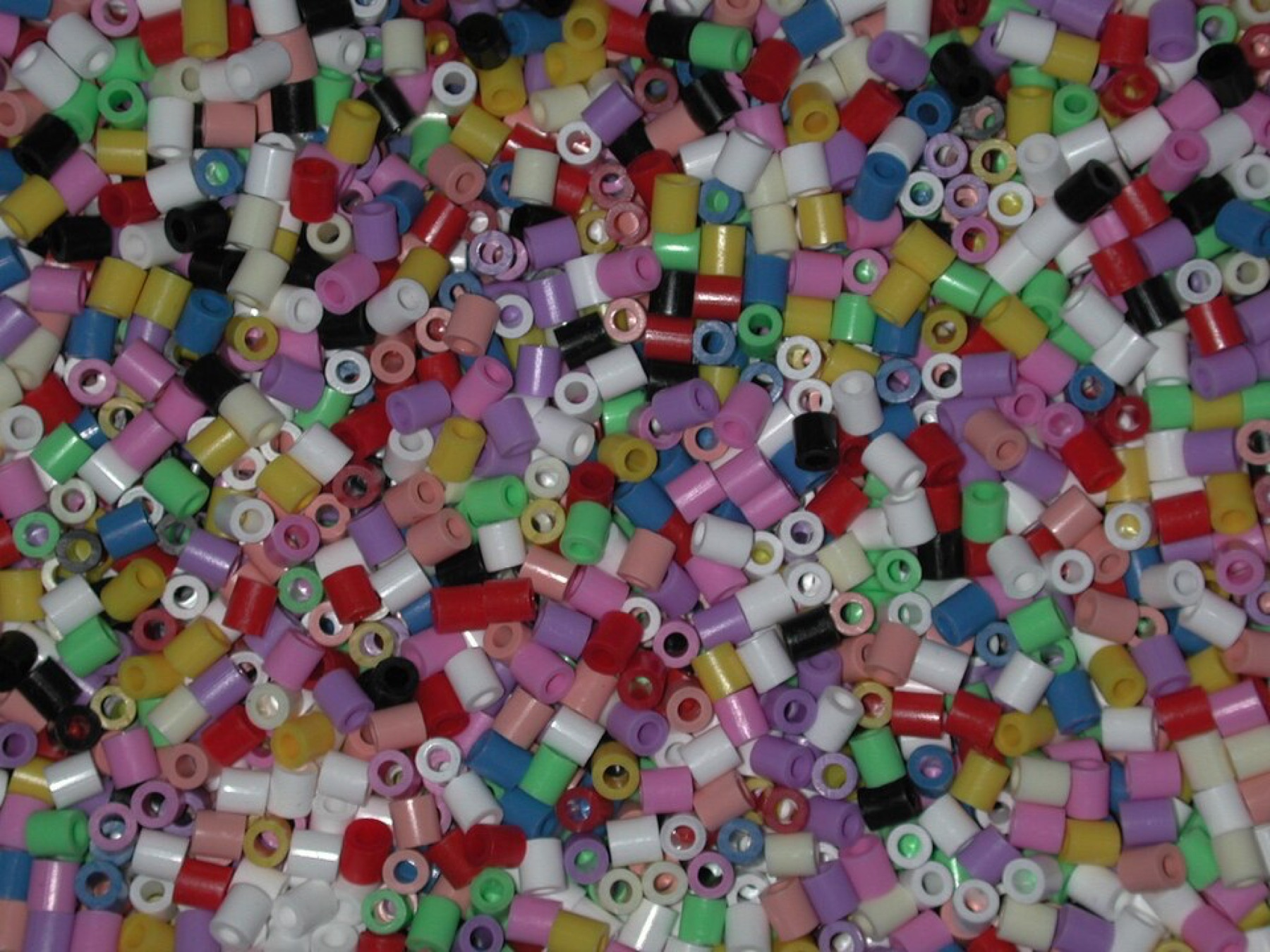 Close-up of colorful fuse beads scattered on a surface