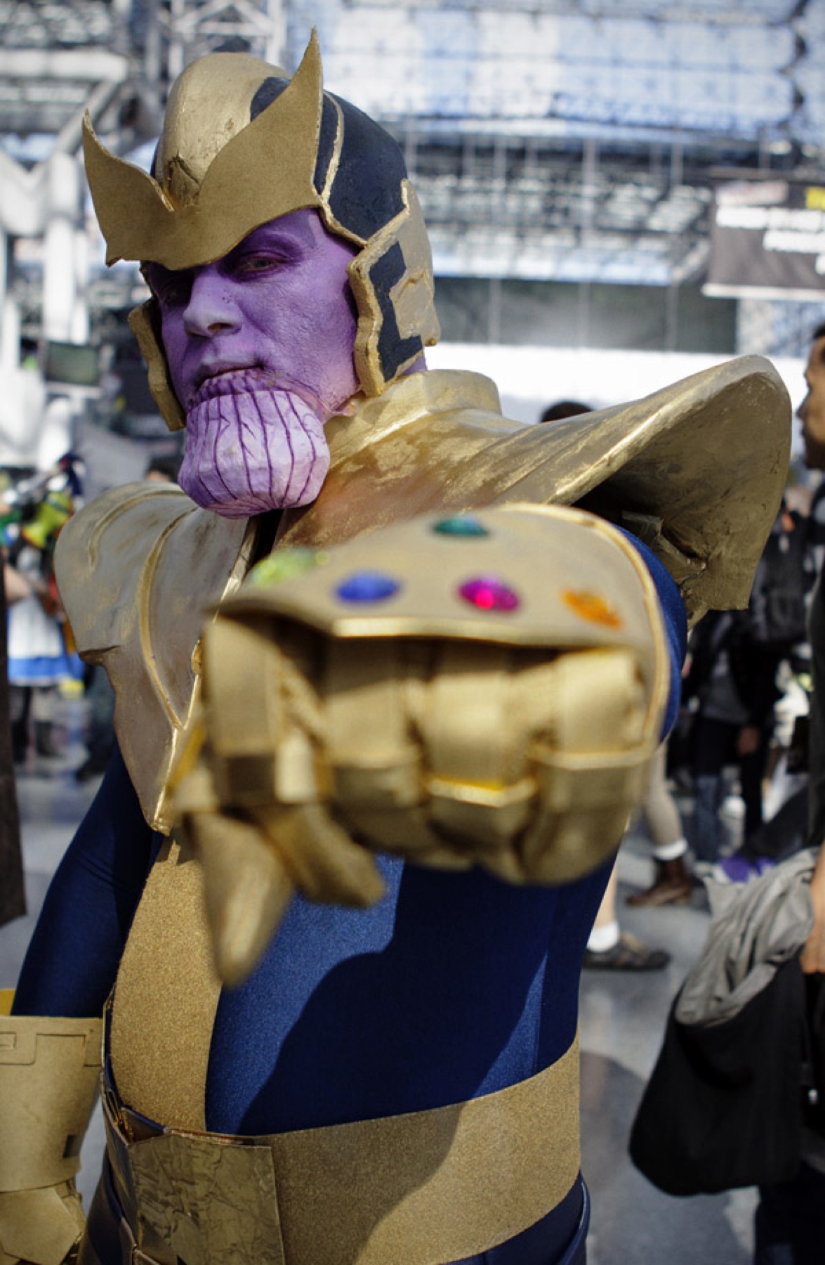 Cosplayer in a detailed Thanos costume with armor and Infinity Gauntlet