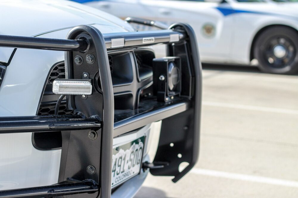 Front bumper of a Dodge Charger police vehicle with wraparound guard