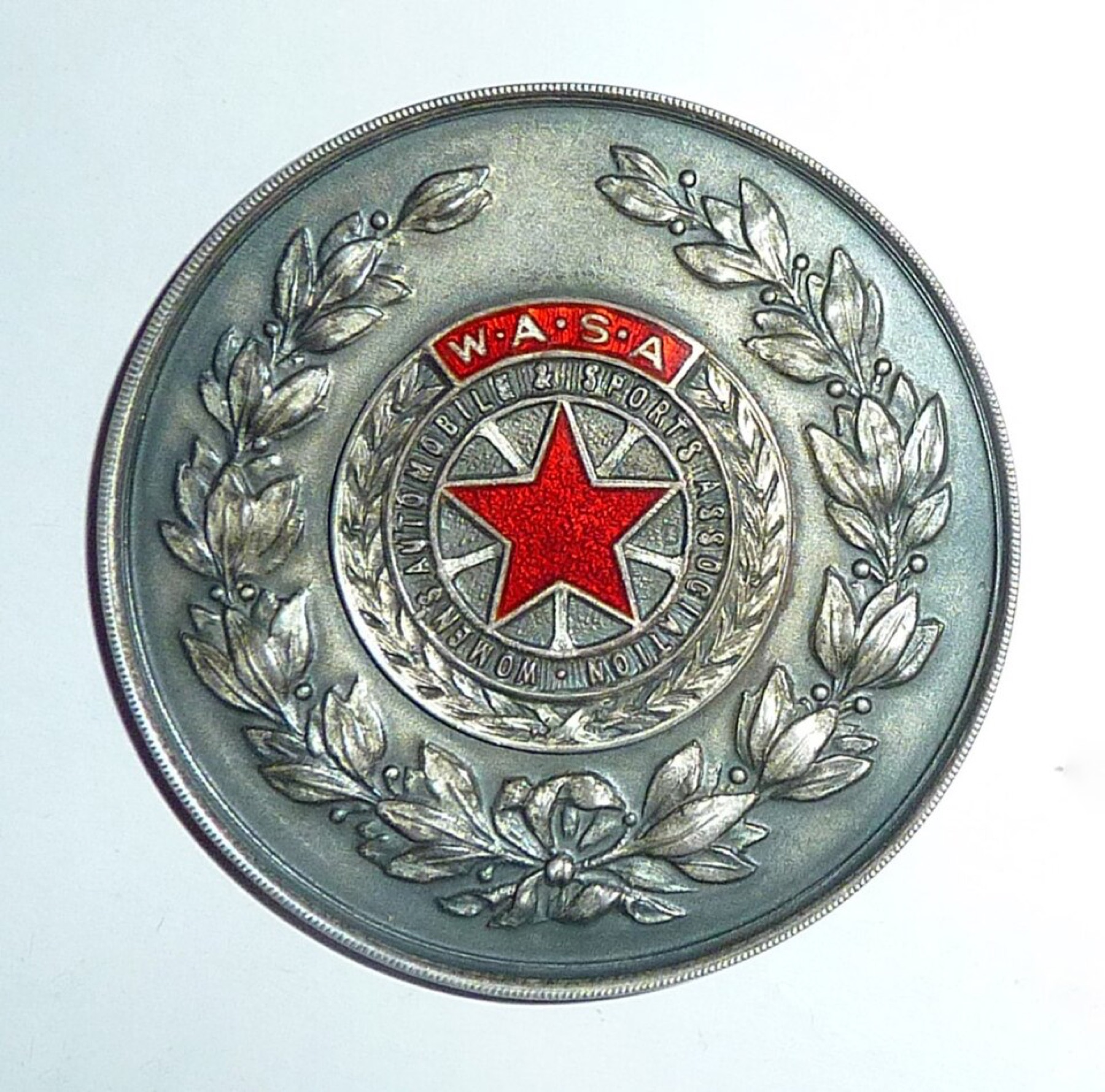 Vintage sports association medals showing size and detail differences