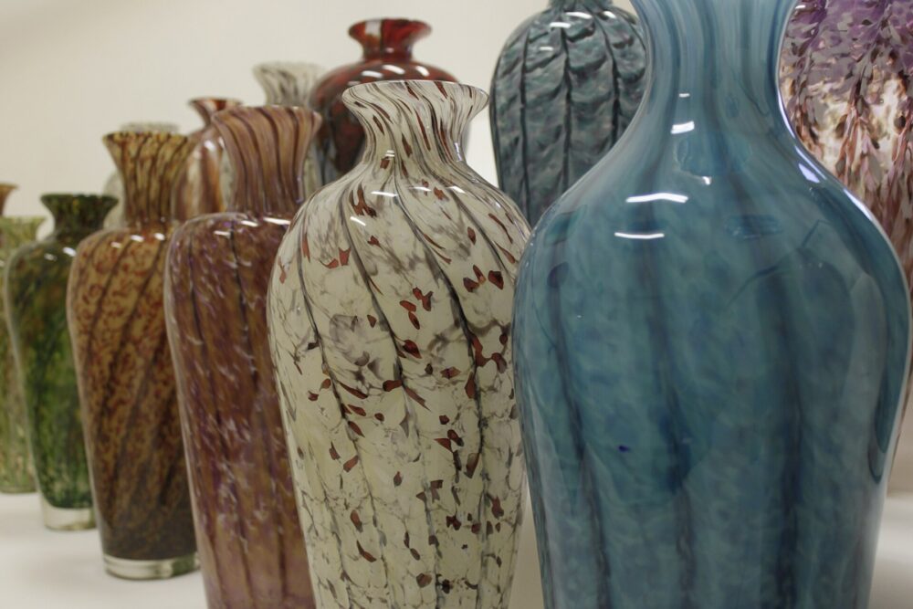 Colorful glass vases displayed on a shelf