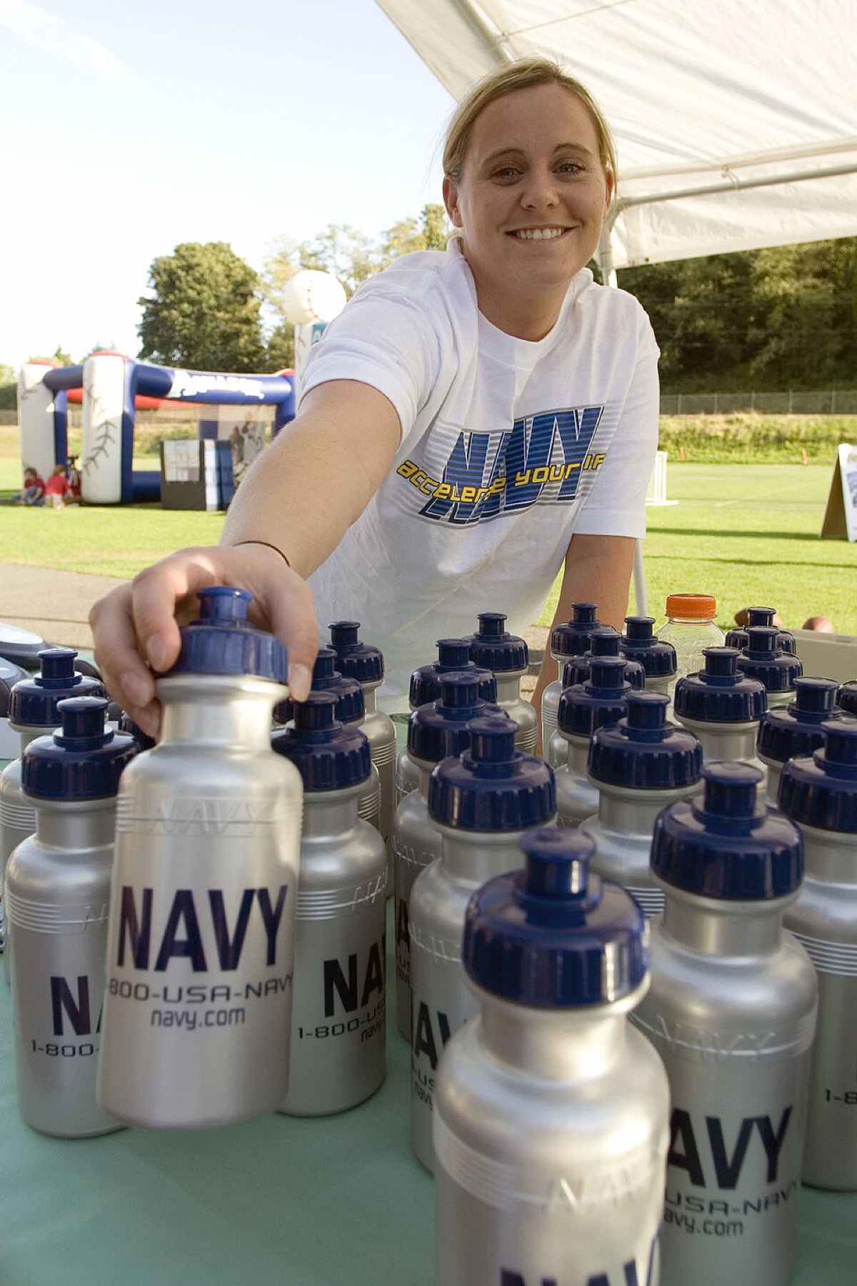 Bulk water bottles organized at a baseball event