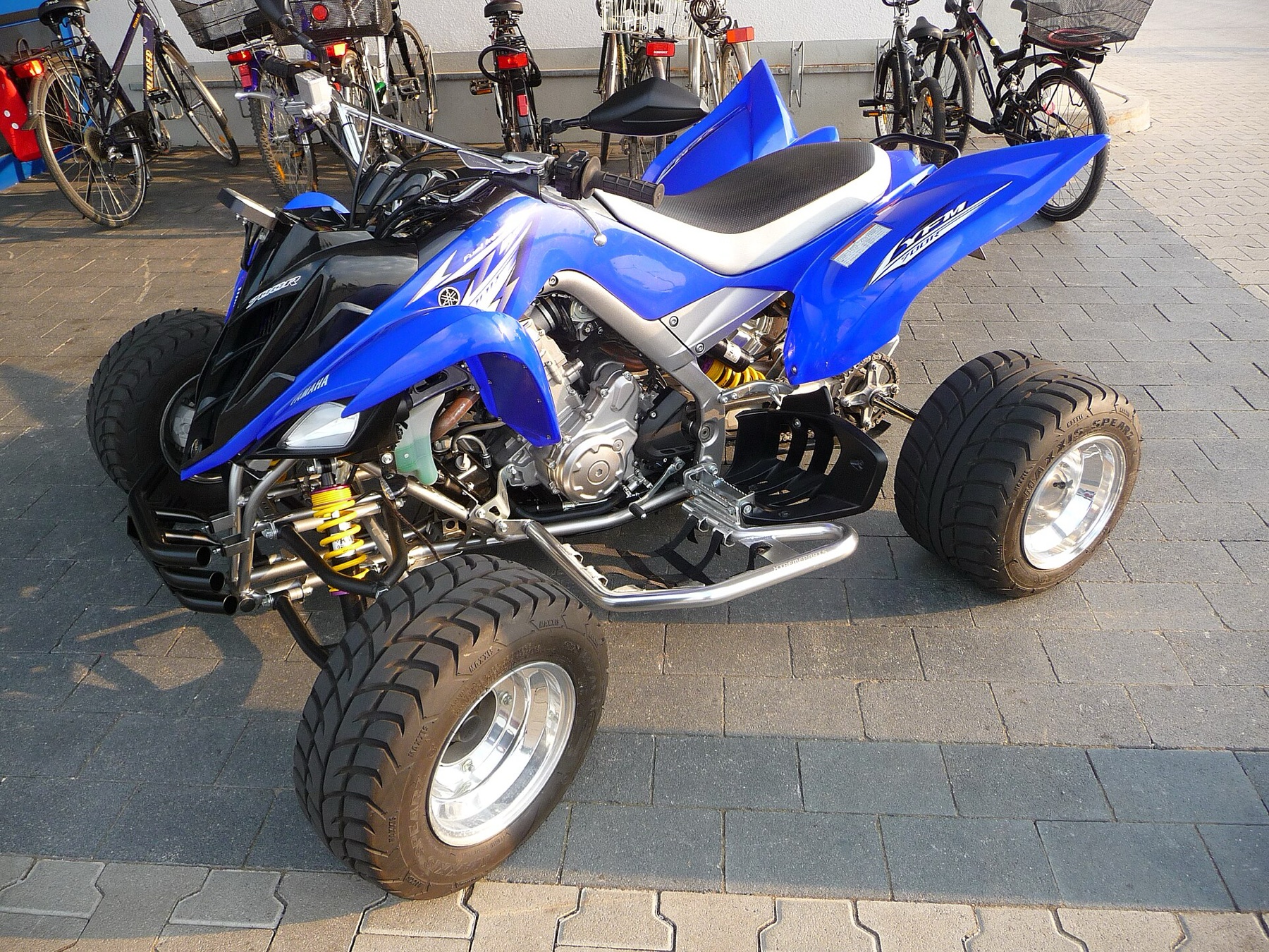 Yamaha Raptor sport ATV parked on grass, side view
