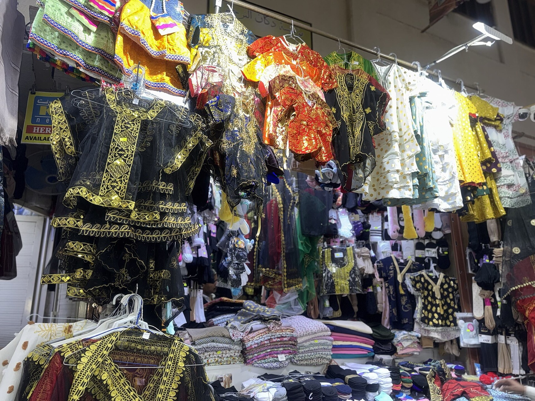 Children's clothing assortment displayed in a shop
