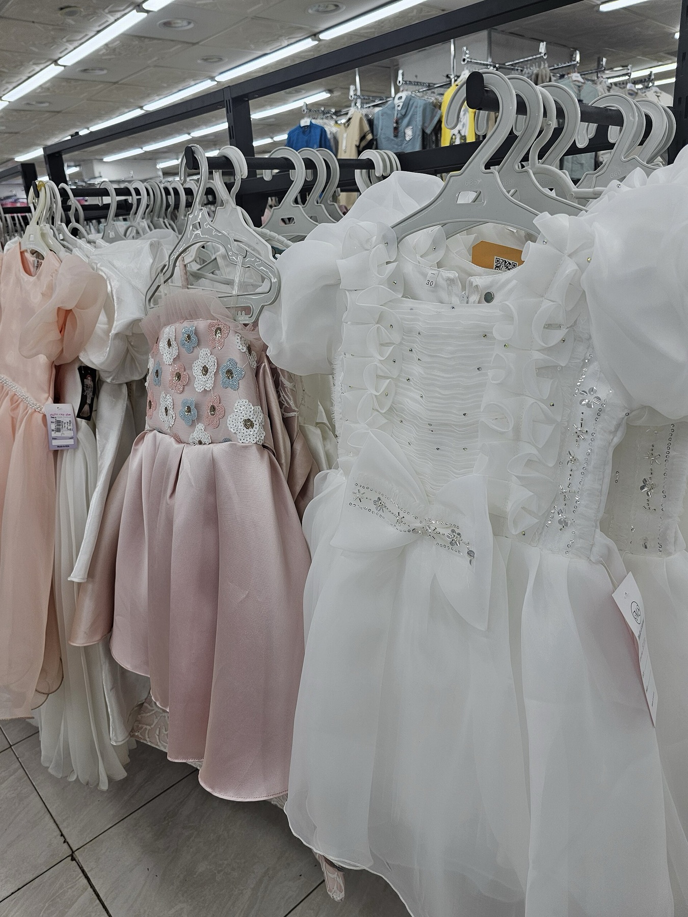 Children's dresses and accessories displayed for retail assortment review