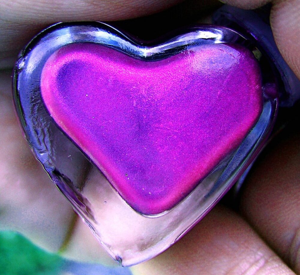Purple nail polish in a heart-shaped bottle, illustrating how bottle design supports branding.