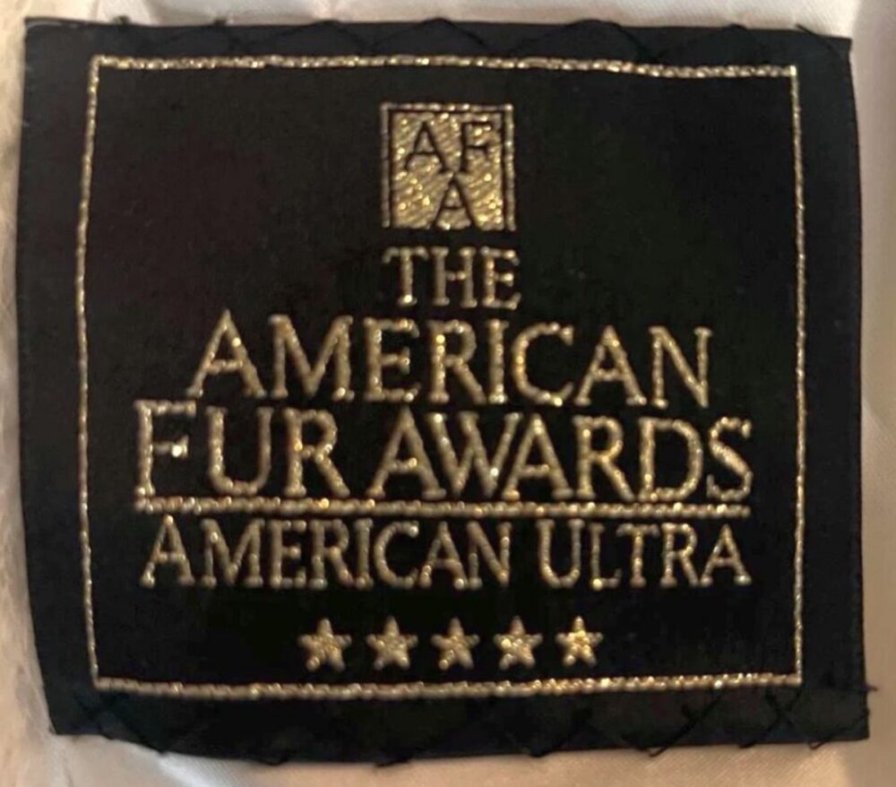 Close-up of a cloth award label sewn into a garment, showing typical award branding.