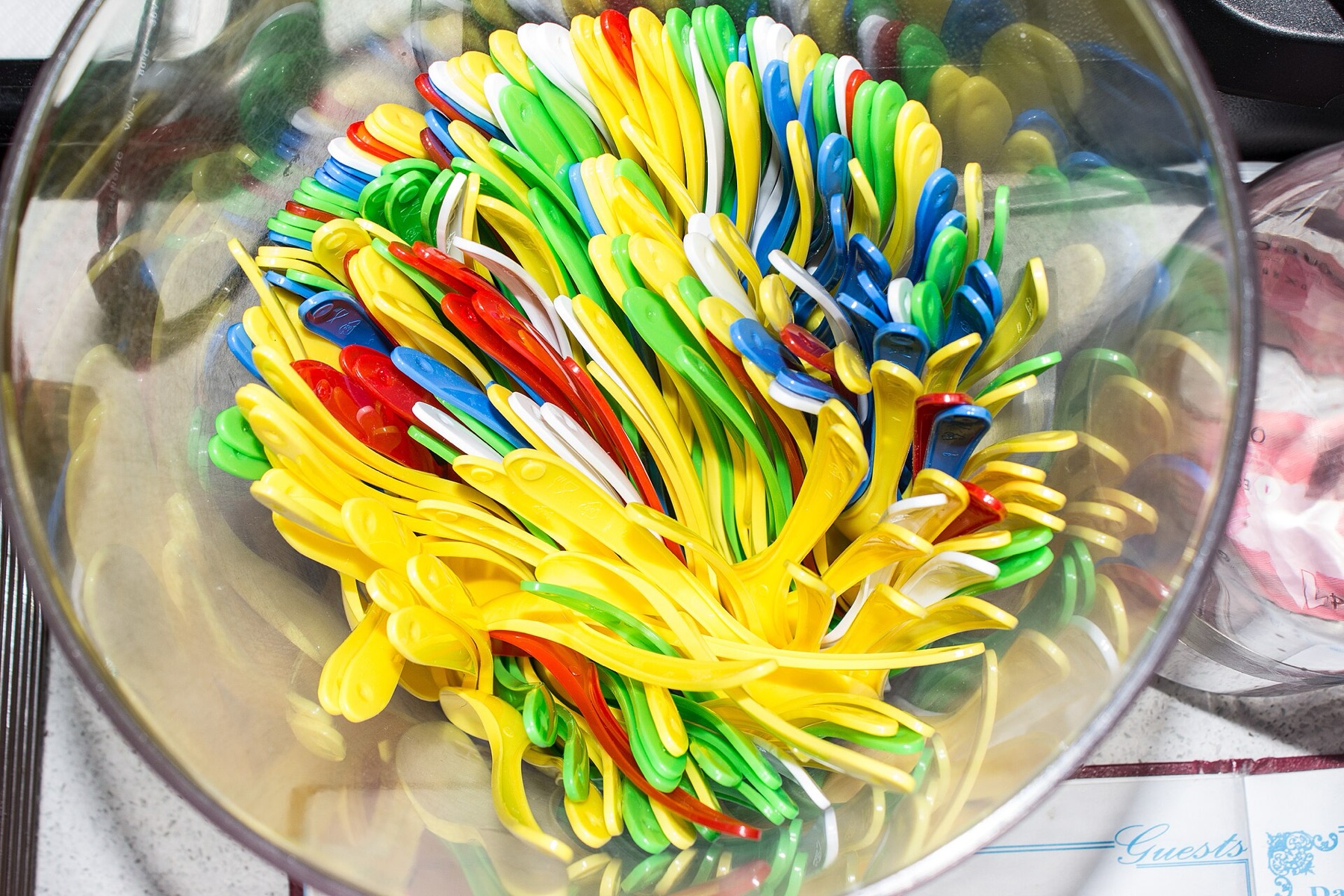 Assorted colorful plastic and metal spoons suitable for serving ice cream