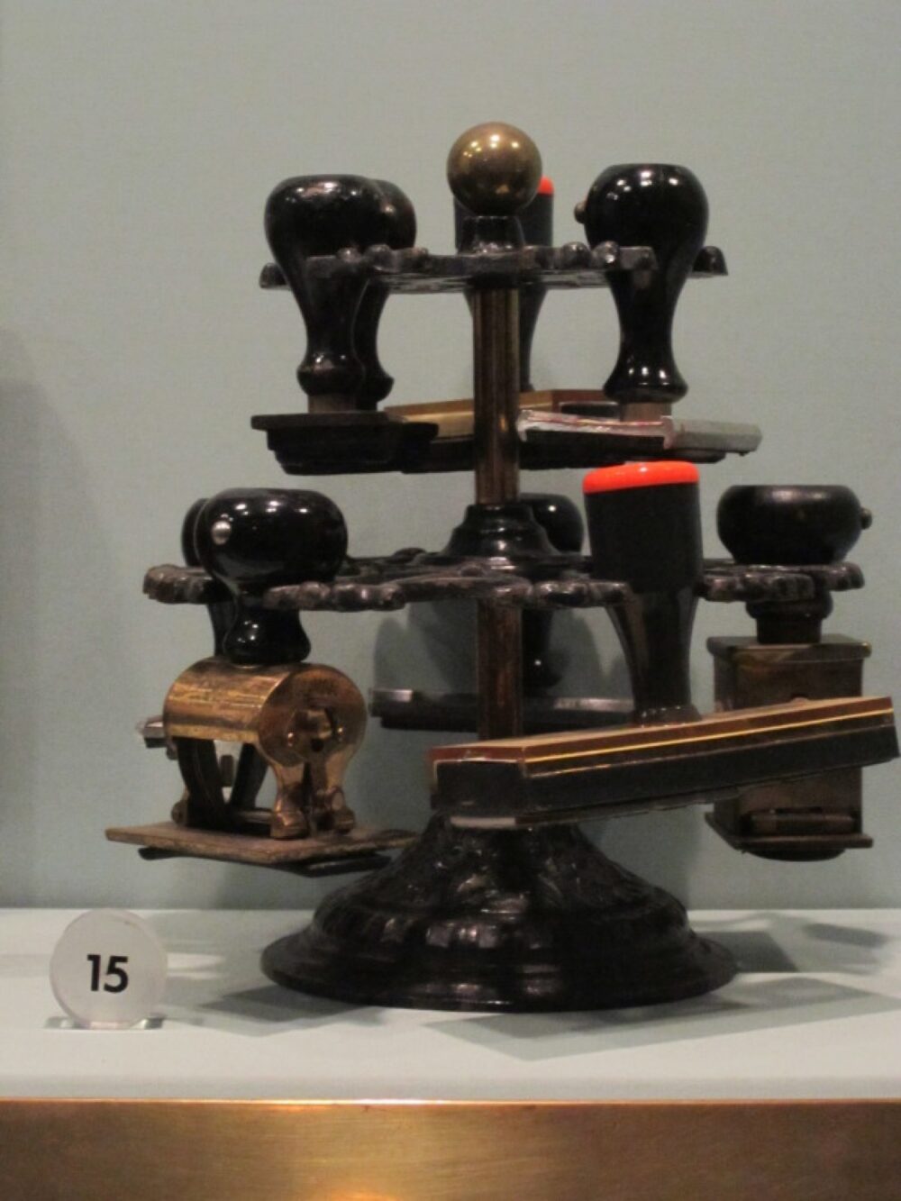Assorted traditional rubber stamps laid out on a desk, illustrating different stamp shapes and handles.