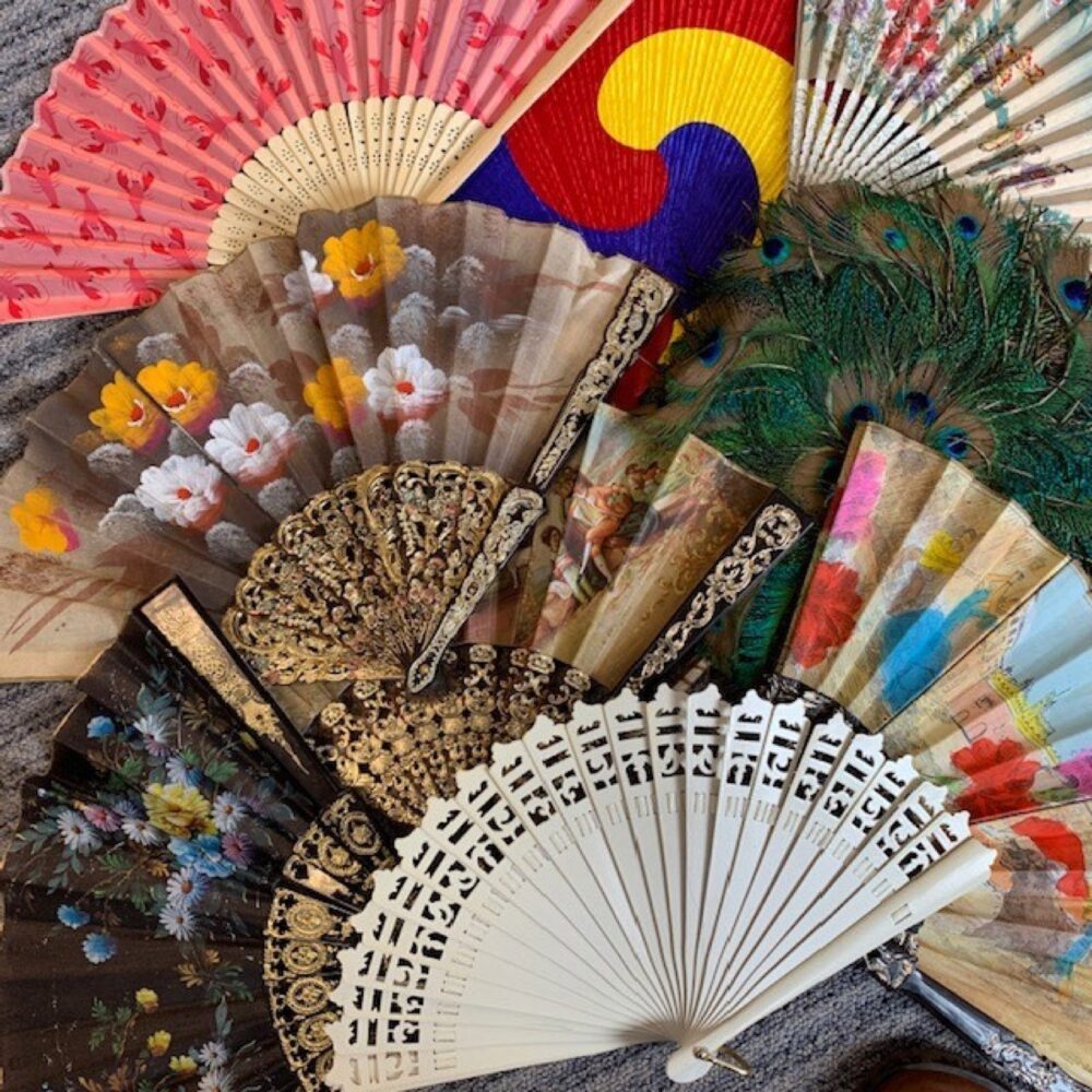 Assorted decorative hand fans in different materials and colors