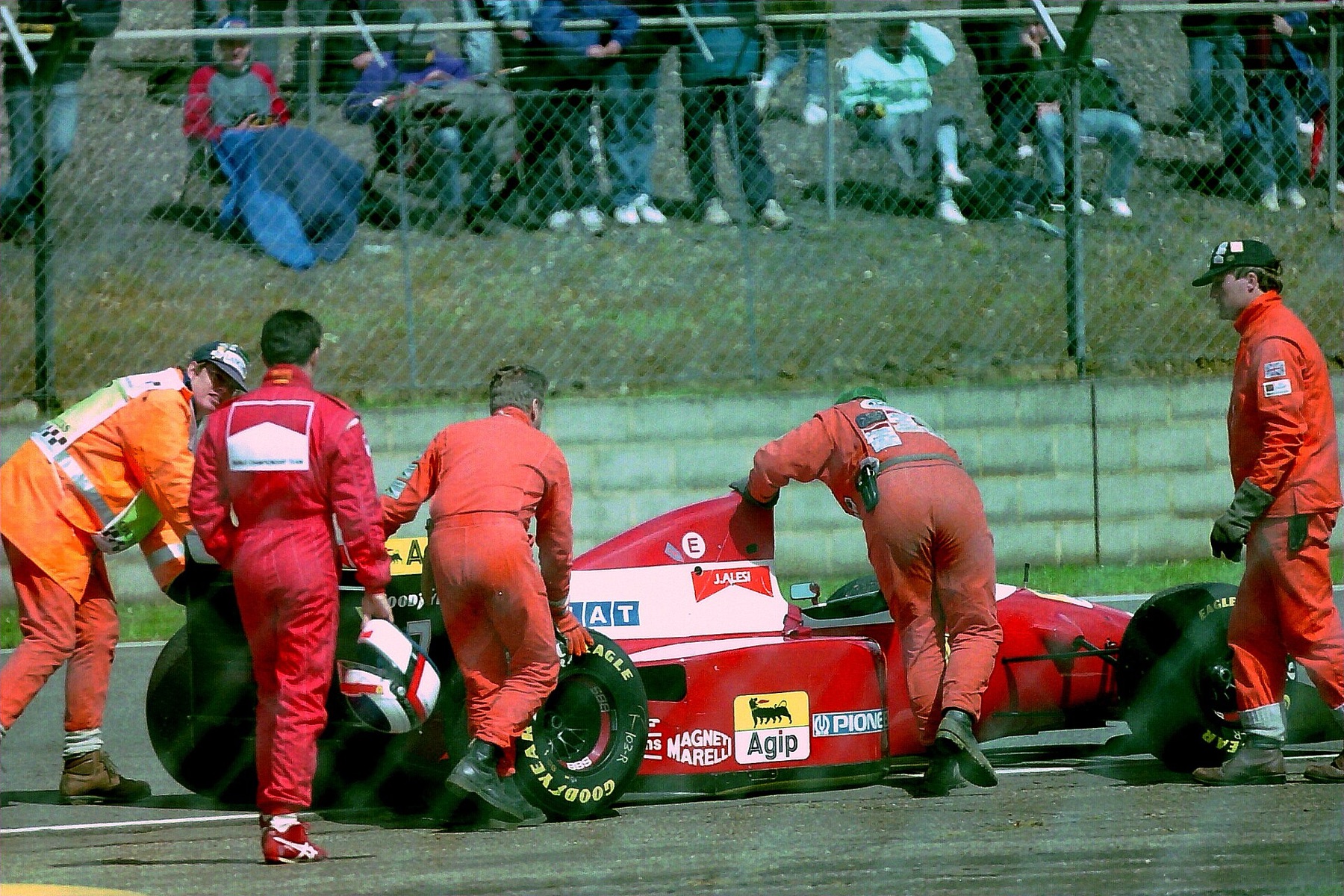 Ferrari F93A Formula 1 car being pushed away as driver Jean Alesi looks on, illustrating Ferrari’s racing heritage that inspires branded watches