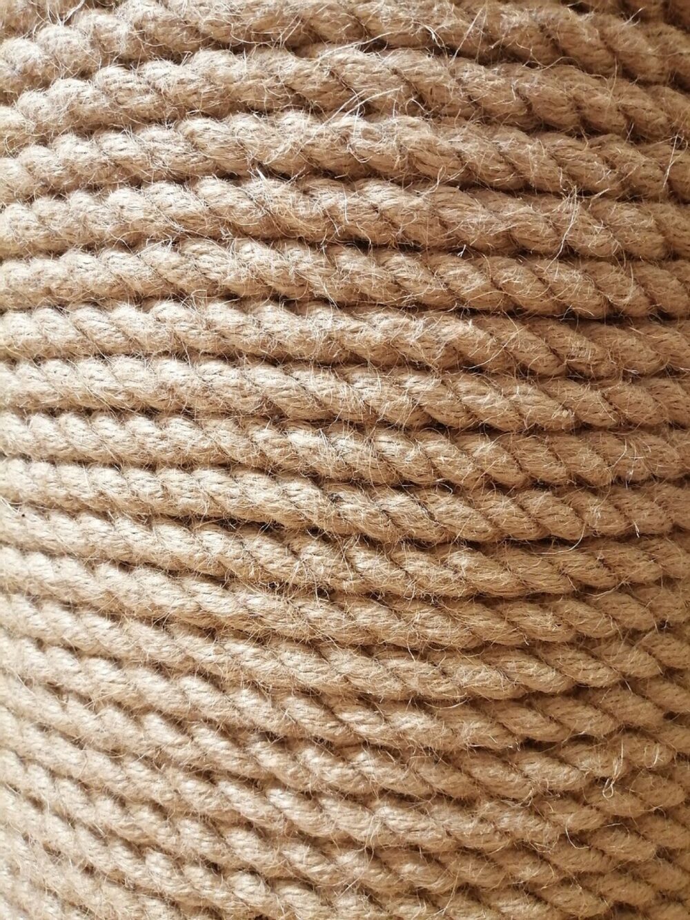 Close-up of natural jute rope fibers, highlighting the texture of decorative and packaging cordage