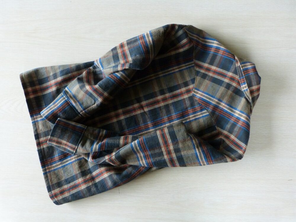 Back view of a plaid flannel shirt showing fabric texture and yoke pattern