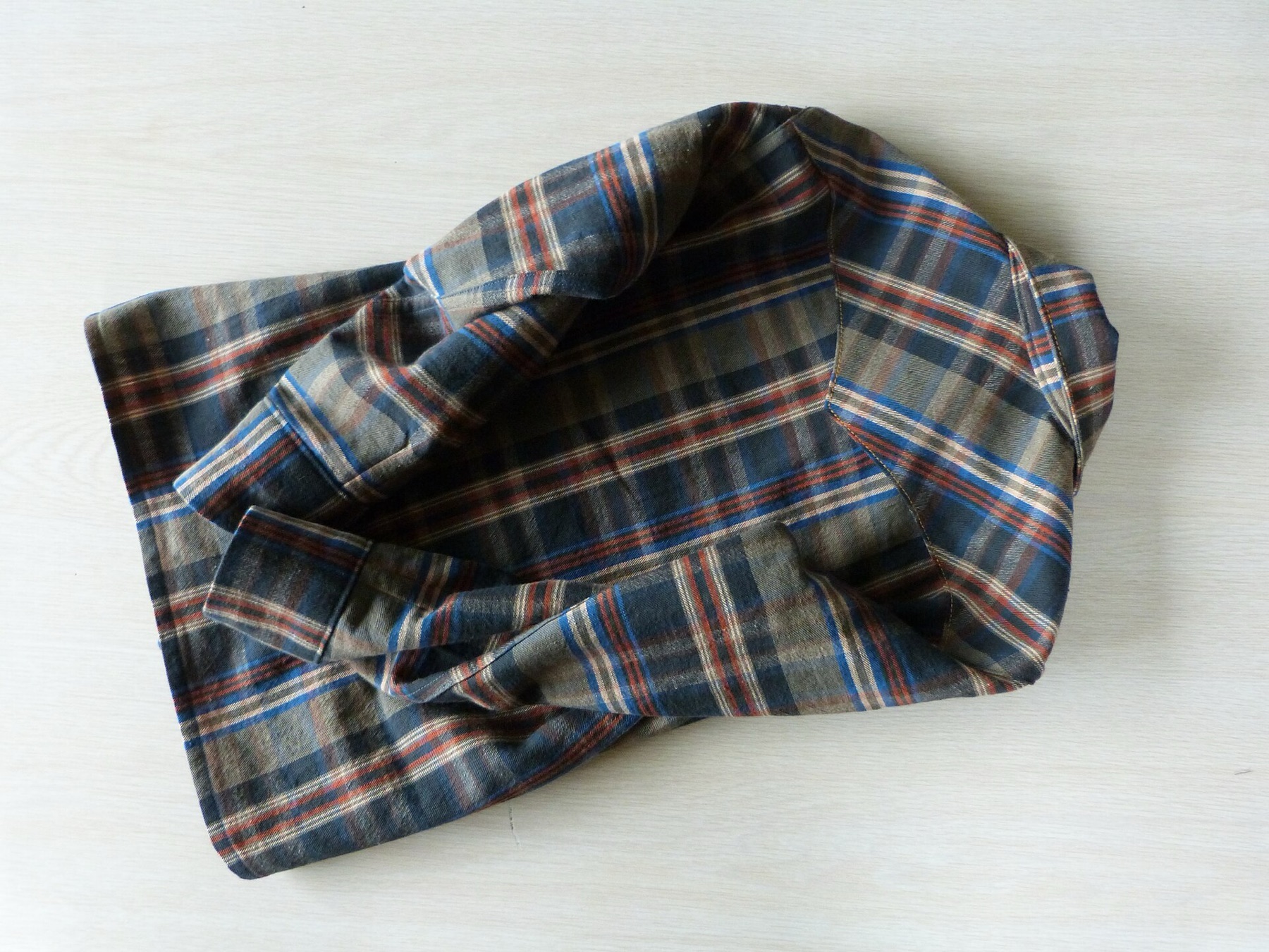 Back view of a plaid flannel shirt showing fabric texture and yoke pattern