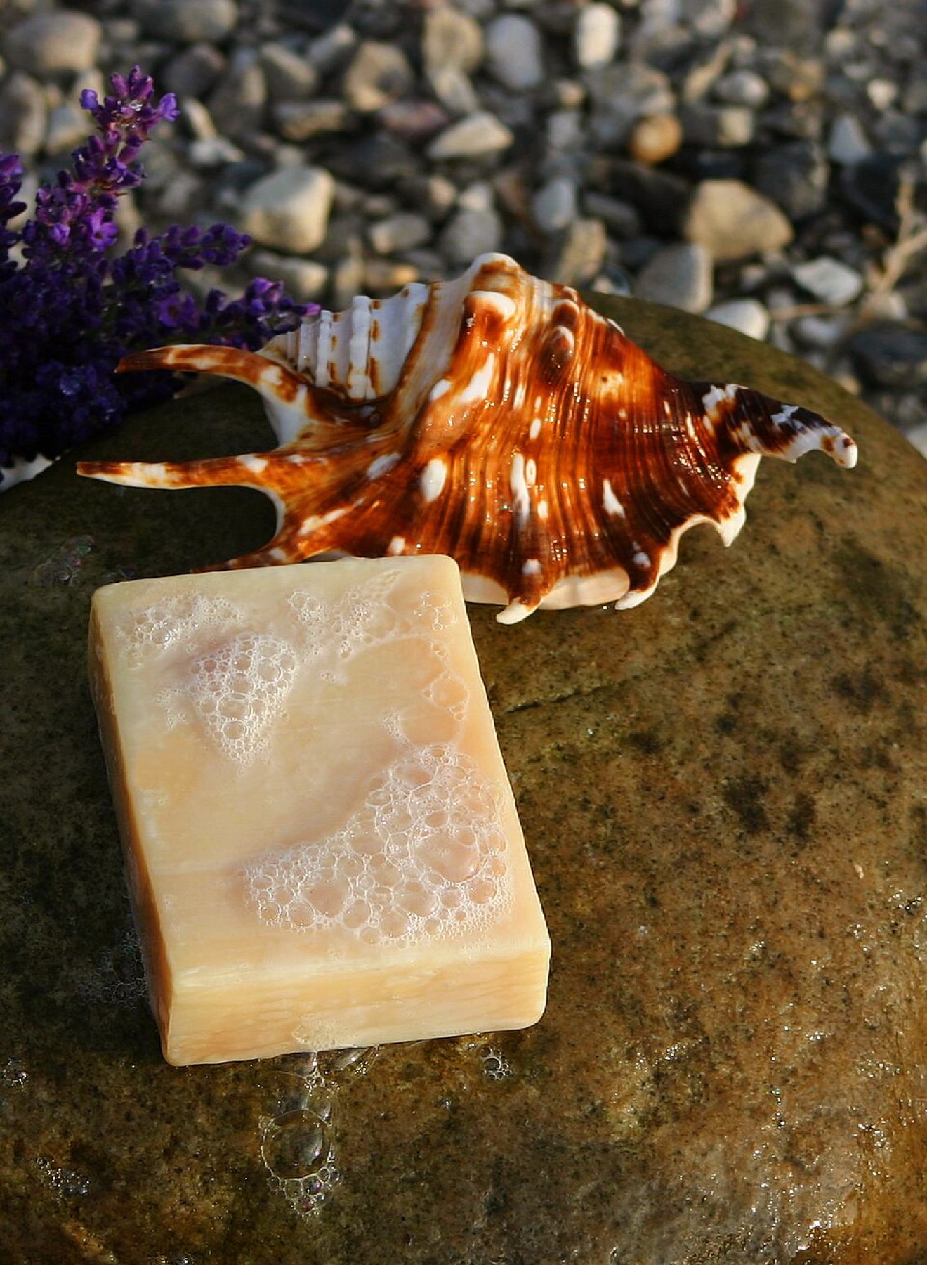 Handmade soap bars stacked near a dish, representing boutique bath products