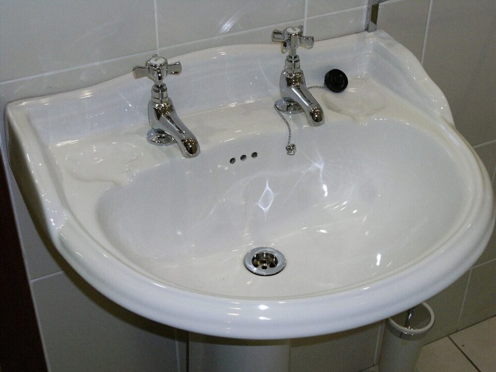 White built-in soap dish in a bathroom sink