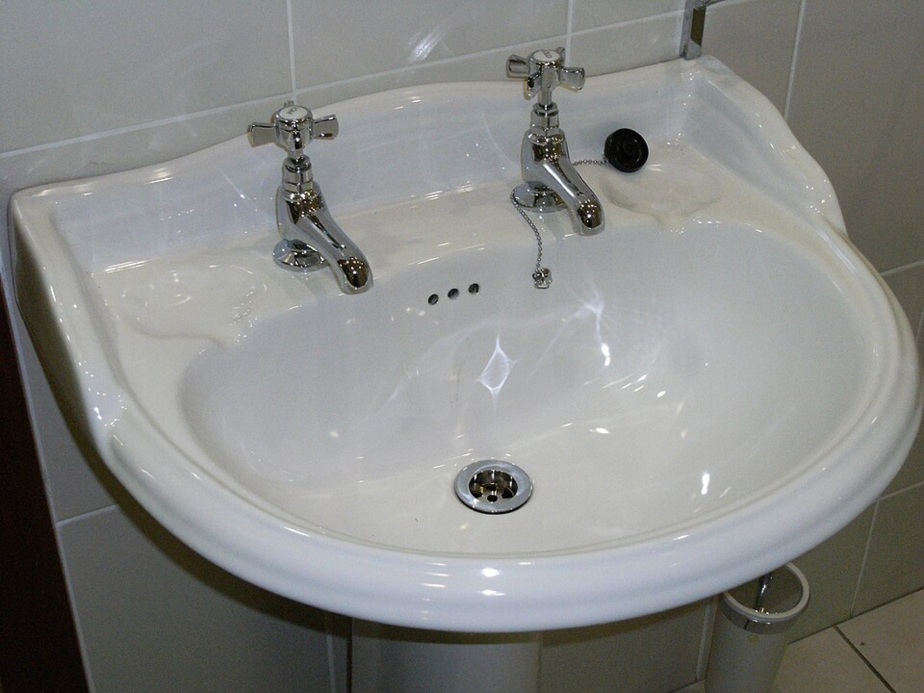 White built-in soap dish in a bathroom sink
