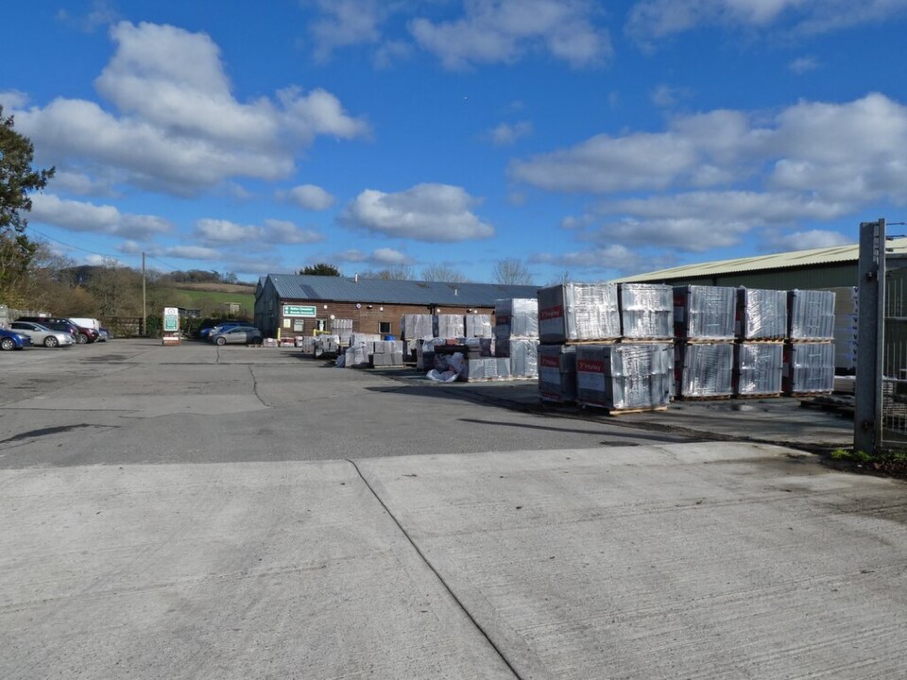 Exterior of a building materials supplier with pallets and stock visible