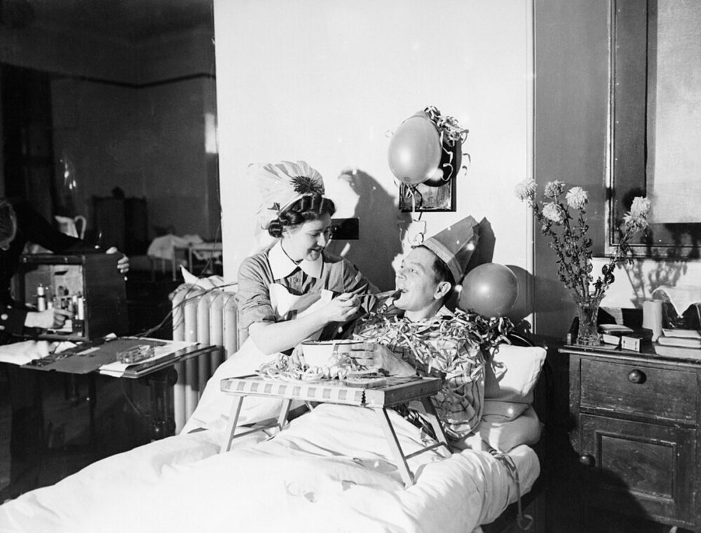 Nurse offering pudding to a patient in a hospital