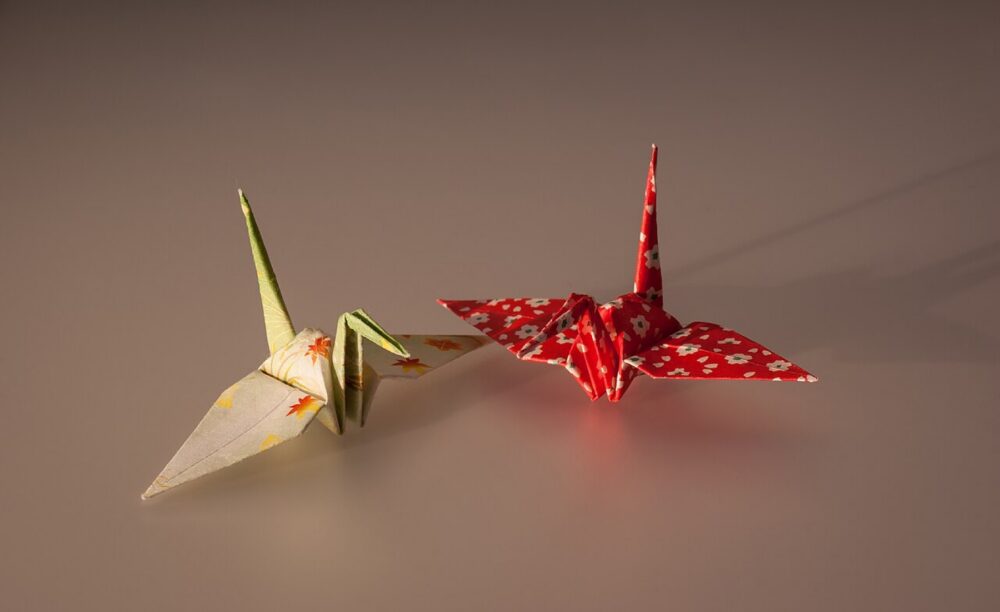 Folded origami cranes illustrating different paper types
