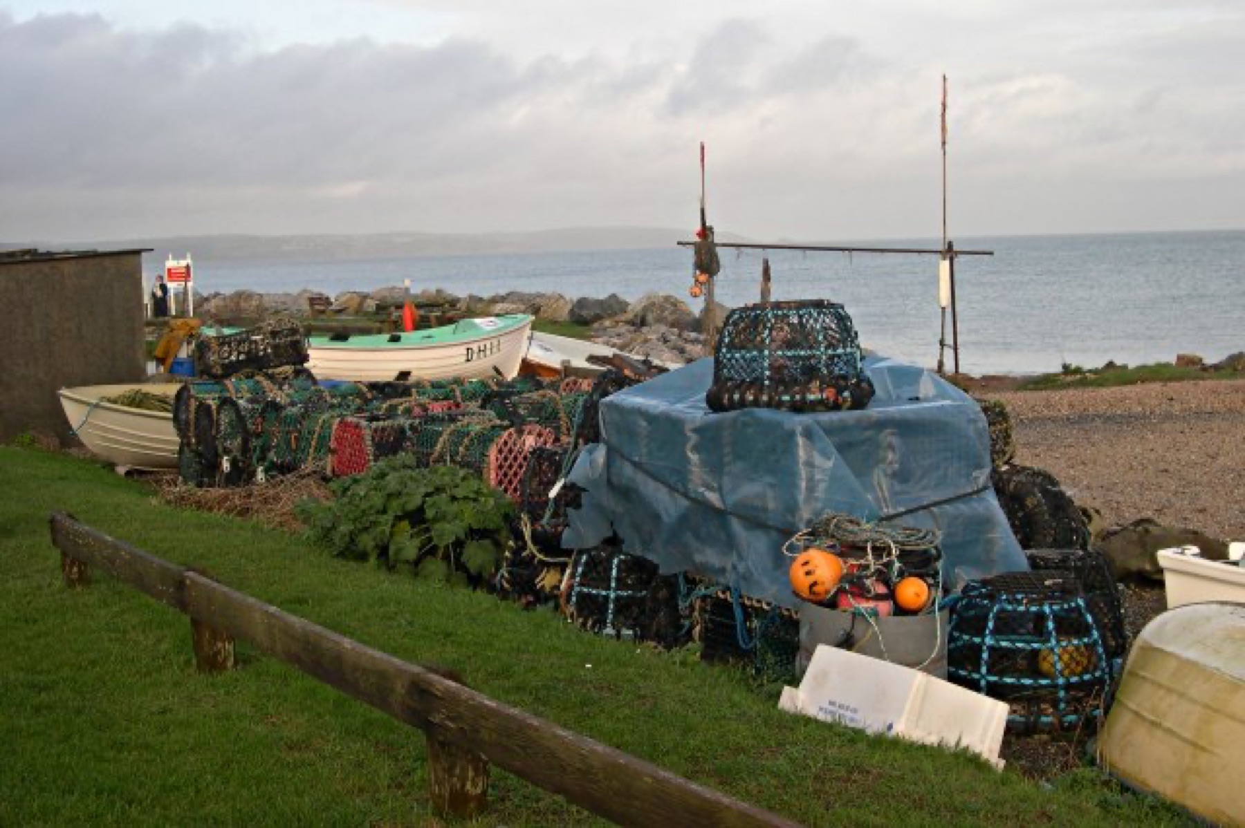 Mixed fishing tackle including nets and traps stacked on a dock