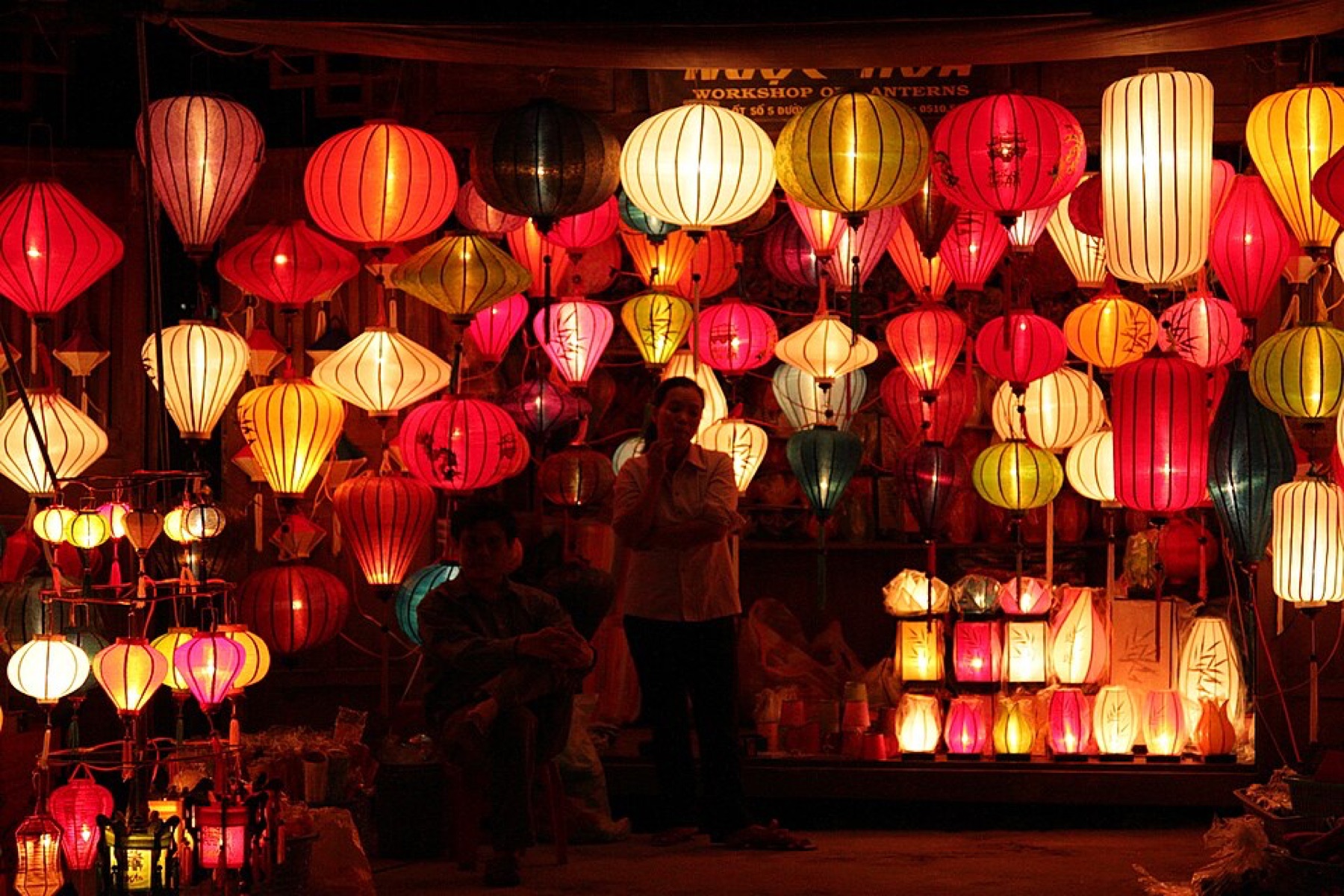Assorted lanterns hanging in a shop, illustrating variety of styles and colors for bulk sourcing