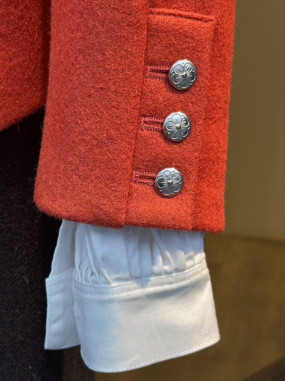 Metal buttons on traditional clothing showing trim detail