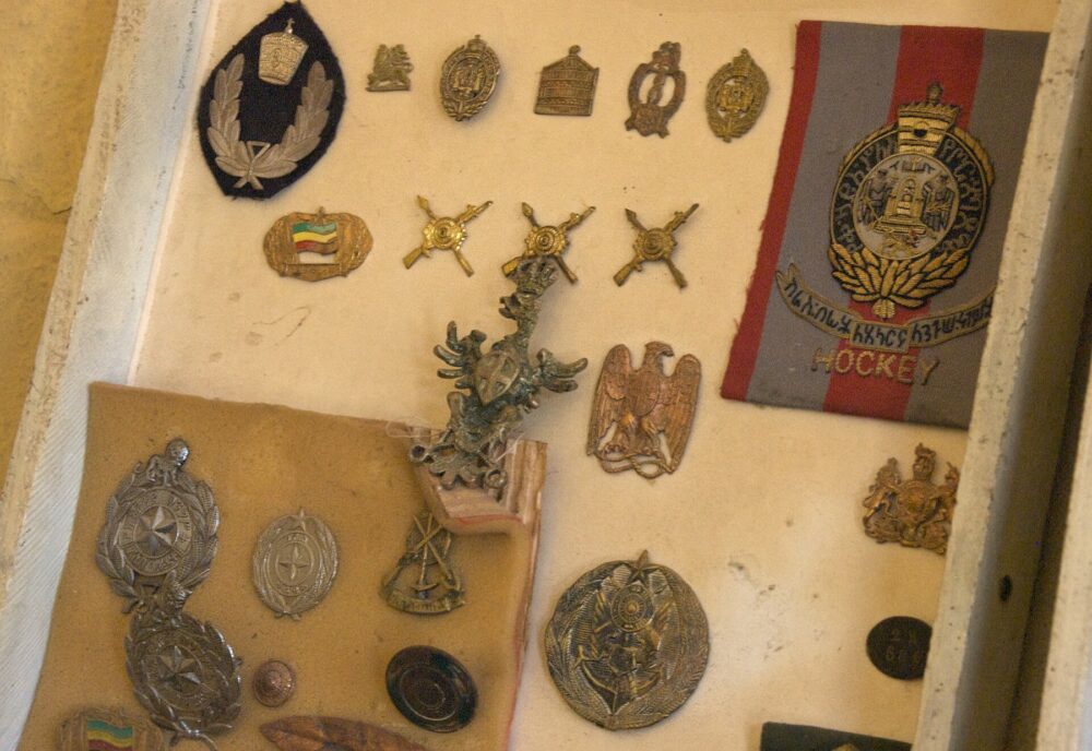 Assorted vintage badges and pins laid out in rows, illustrating the variety of pin styles a reseller might source