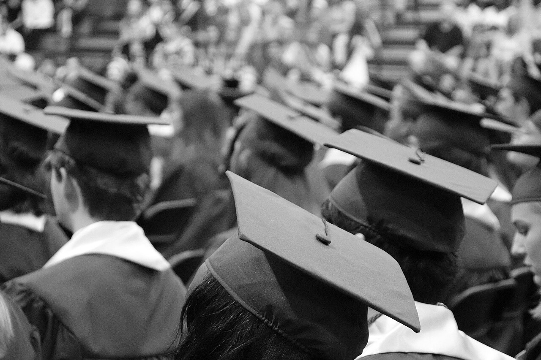 Black graduation cap on a desk