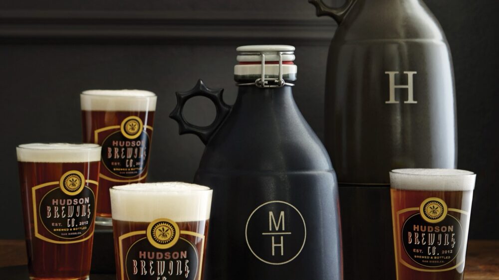 Personalized pub pint glasses and beer growler on a bar