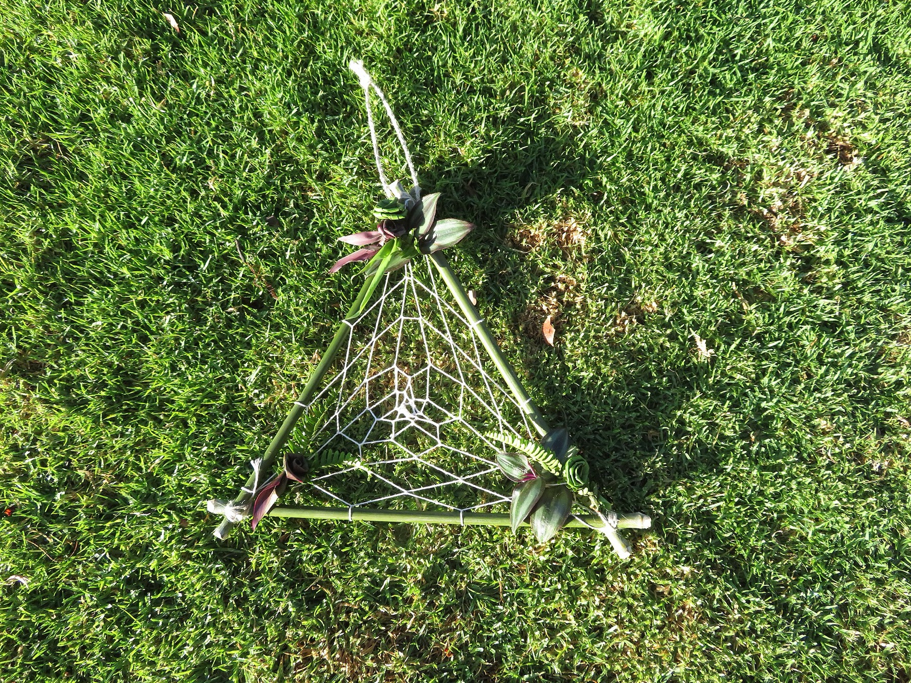Handmade decorative gift with hanging ornaments and ribbons.