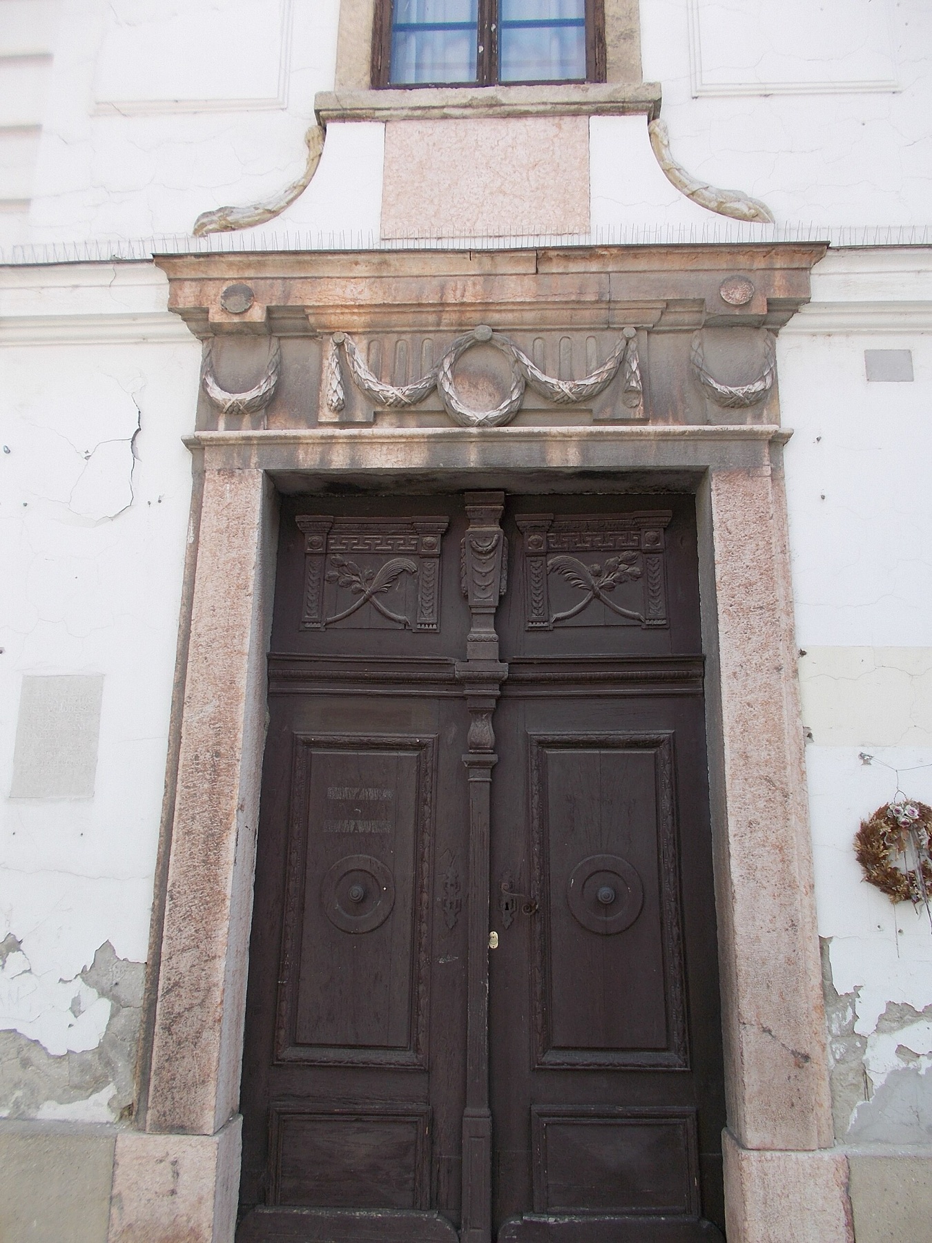 Stone-framed gate with garland decor