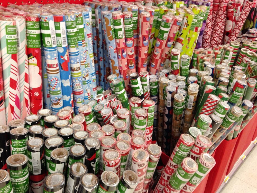 Store display of assorted wrapping paper rolls illustrating typical formats and widths