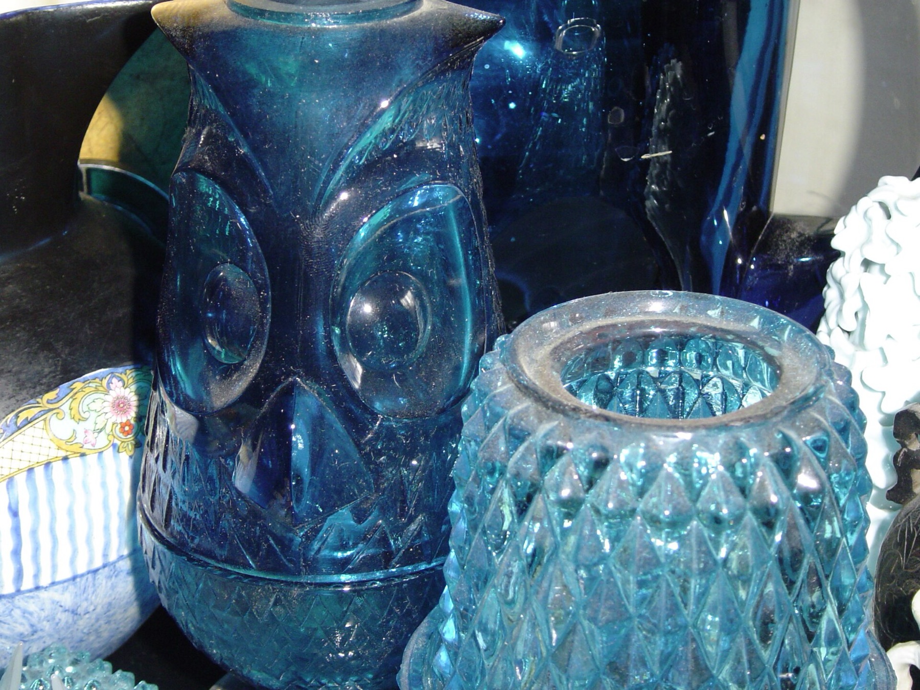 Assorted blue glassware pieces displayed on a table