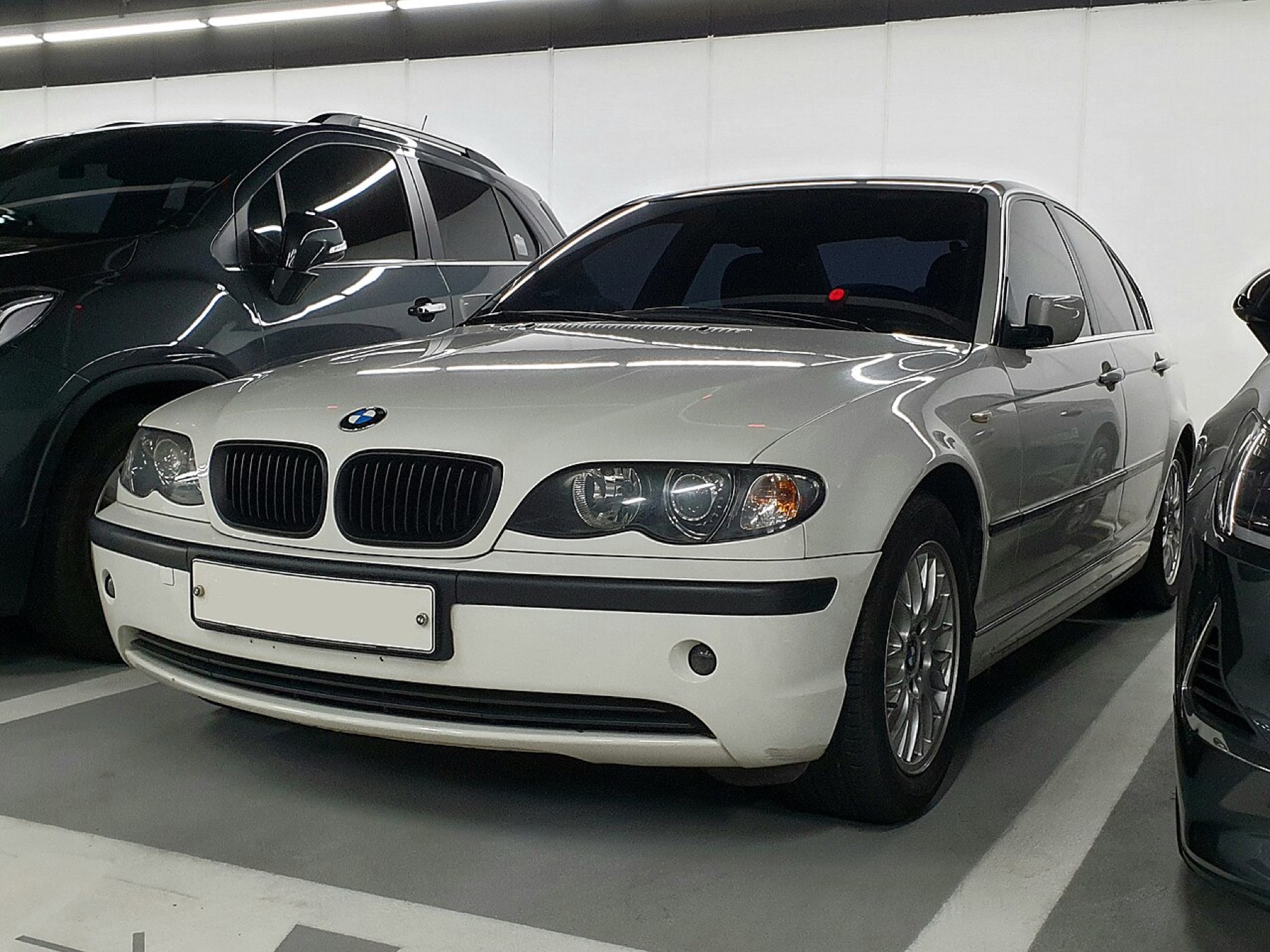 BMW E46 front three-quarter view, showing stock headlights that can be upgraded with xenon, angel eyes or LED kits