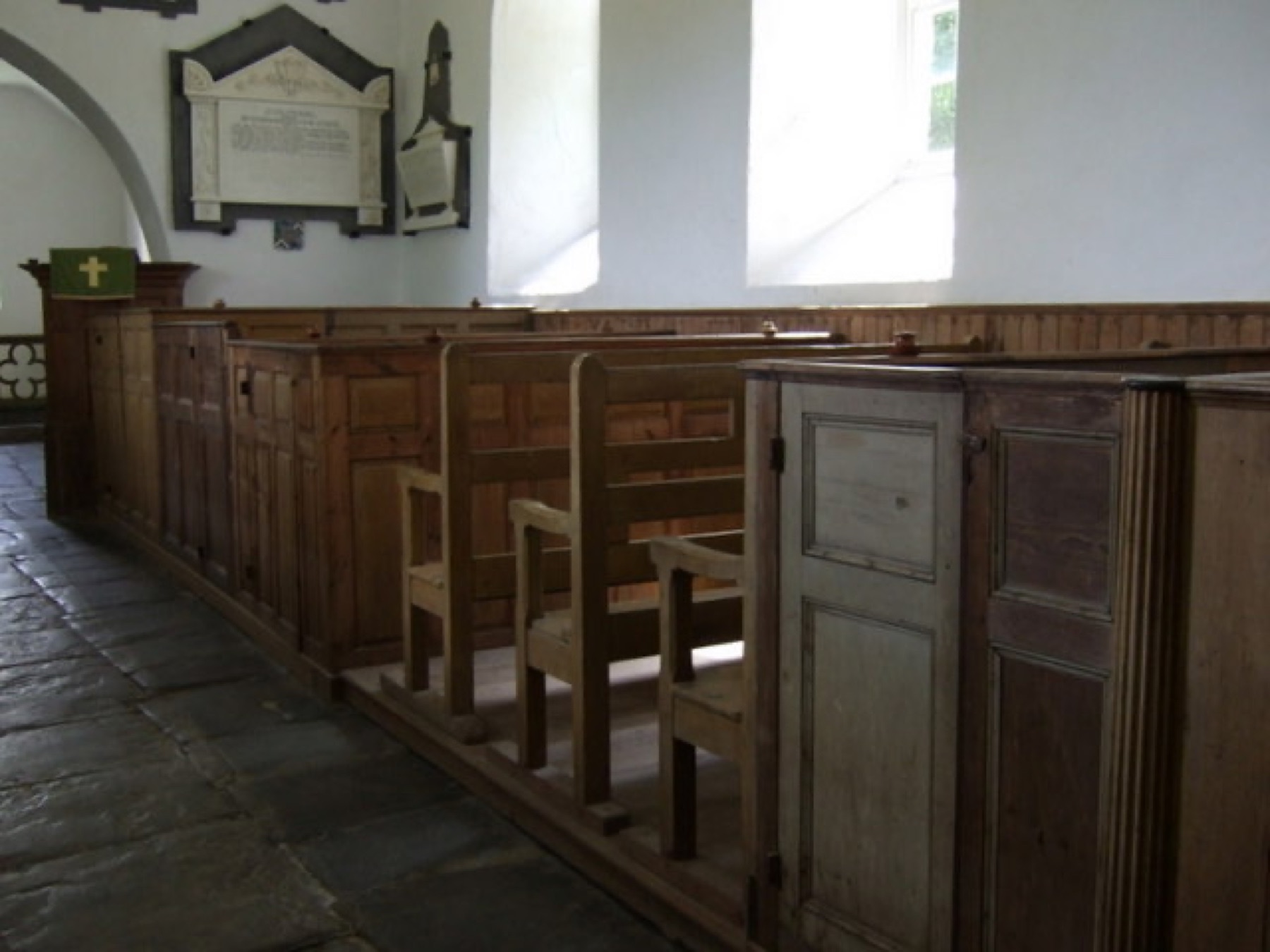 Interior of a traditional church with long wooden pews, illustrating the scale and permanence of fixed sanctuary seating.