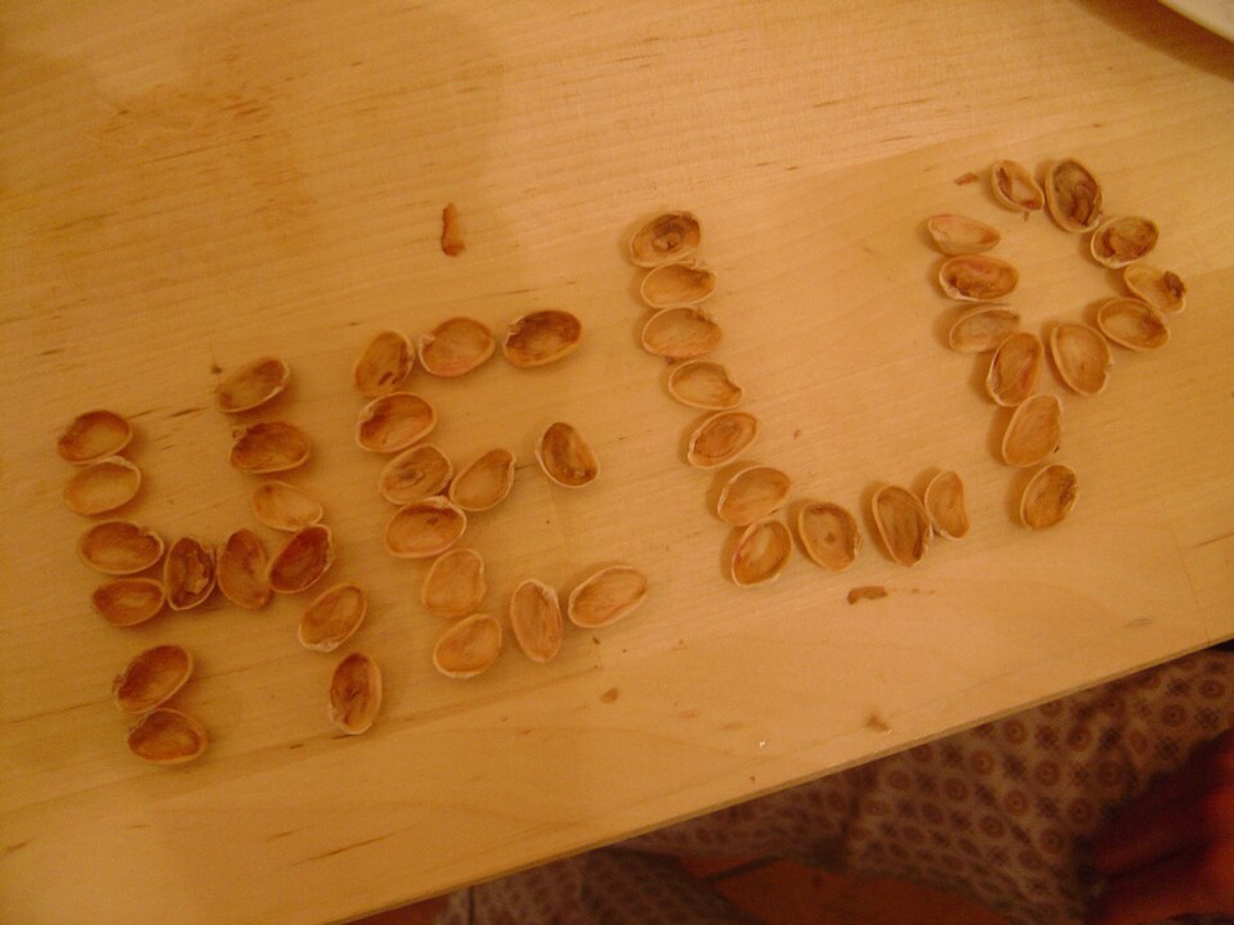 Pistachio nut shells arranged to spell the word help