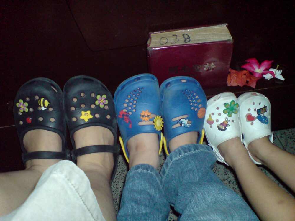 Crocs shoes decorated with multiple Jibbitz shoe charms