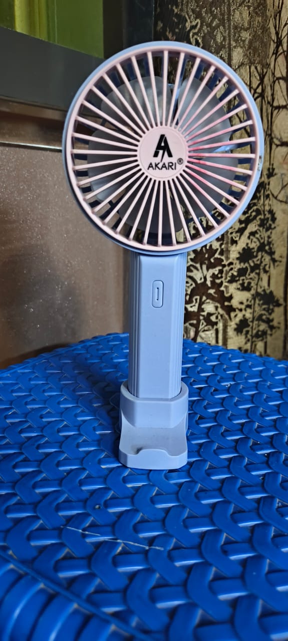 A compact portable mini fan photographed upright for a clear view of its size and form