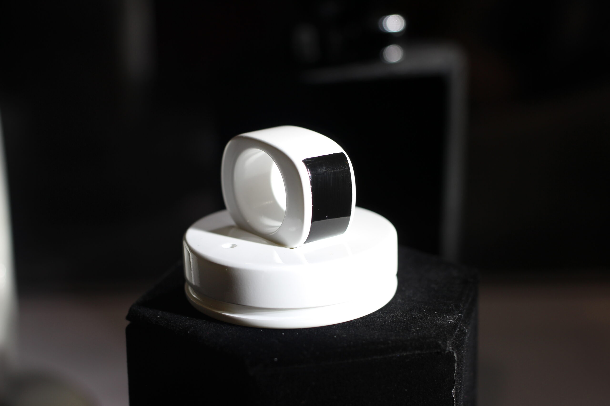 A generic MOTA smart ring displayed on a stand