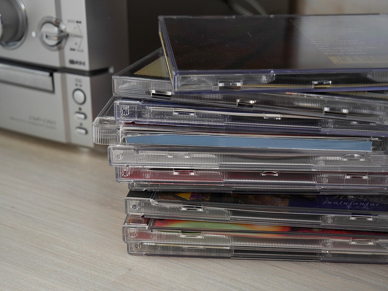A stack of music CDs stored in jewel cases