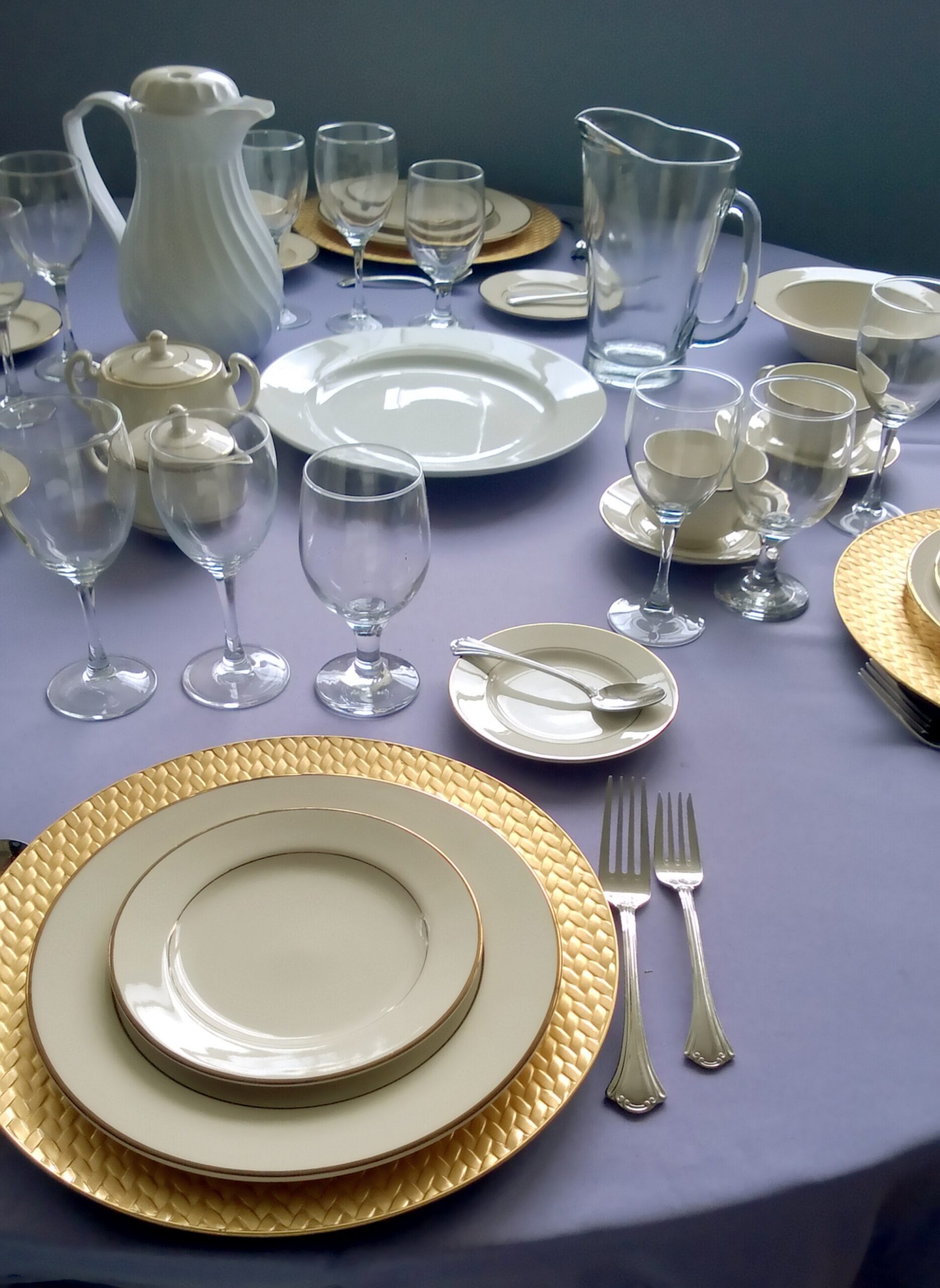 Gold and white tableware arranged as a party-store display for event-supply buyers