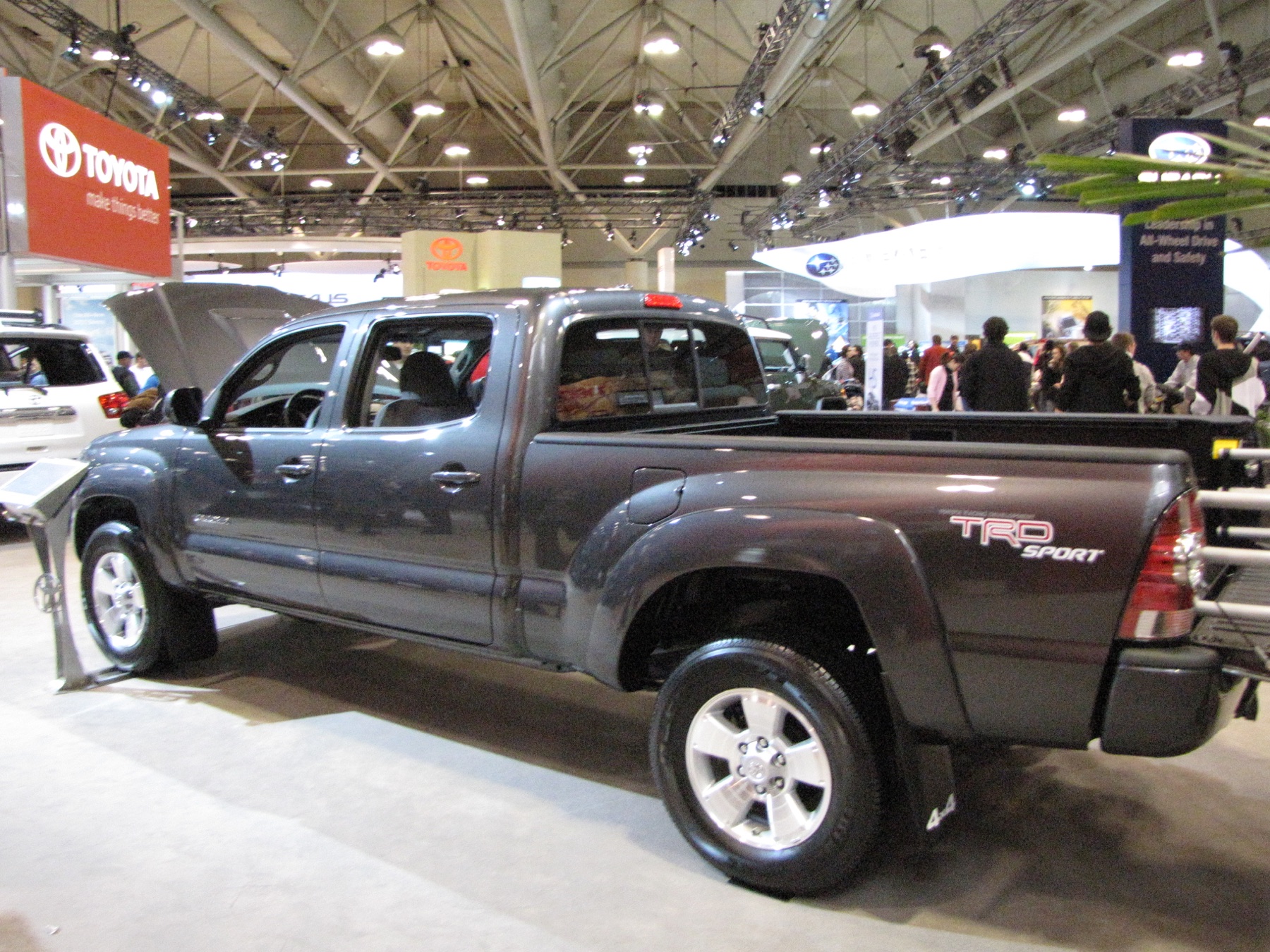 Toyota Tacoma with its hood open at an auto show