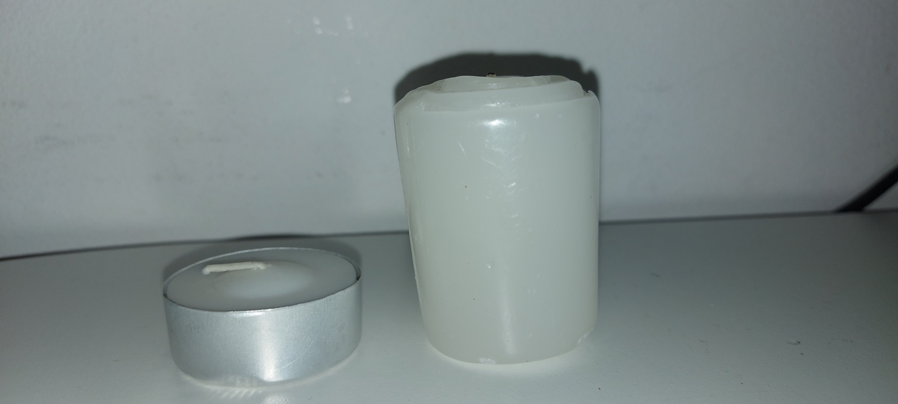 Generic tealight and votive candles illustrating two formats to compare for event orders