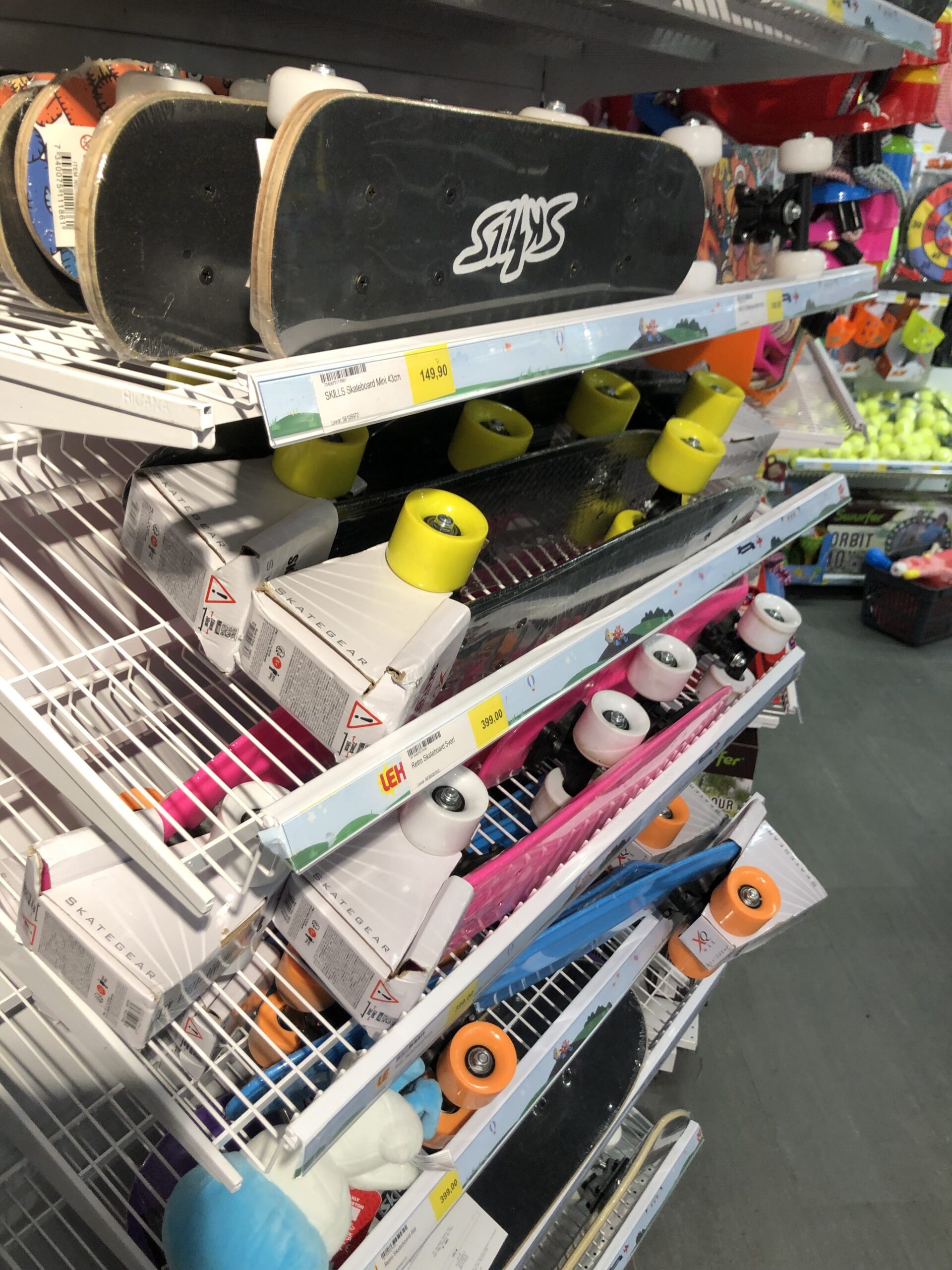 Toy-store shelves showing different products and price labels that buyers need to compare